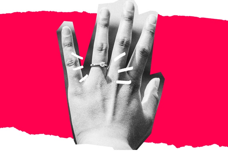 An engagement ring on an outstretched hand.